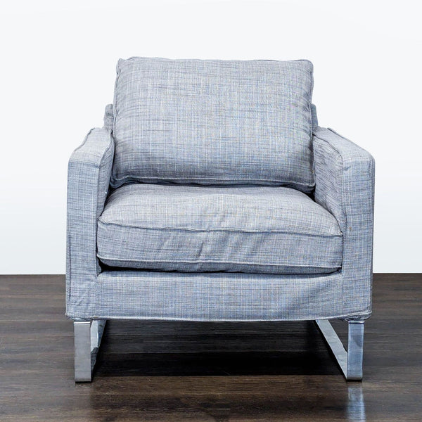 Modern gray Ikea lounge chair with textured fabric, plush cushions, and metal legs, ideal for lounge spaces.
