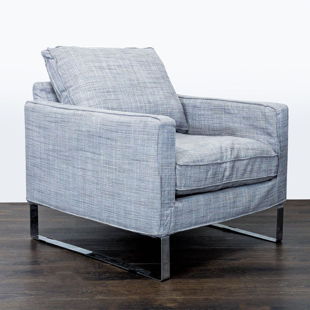 Plush gray lounge chair by Ikea, featuring soft fabric and metal legs, perfect for modern living rooms.