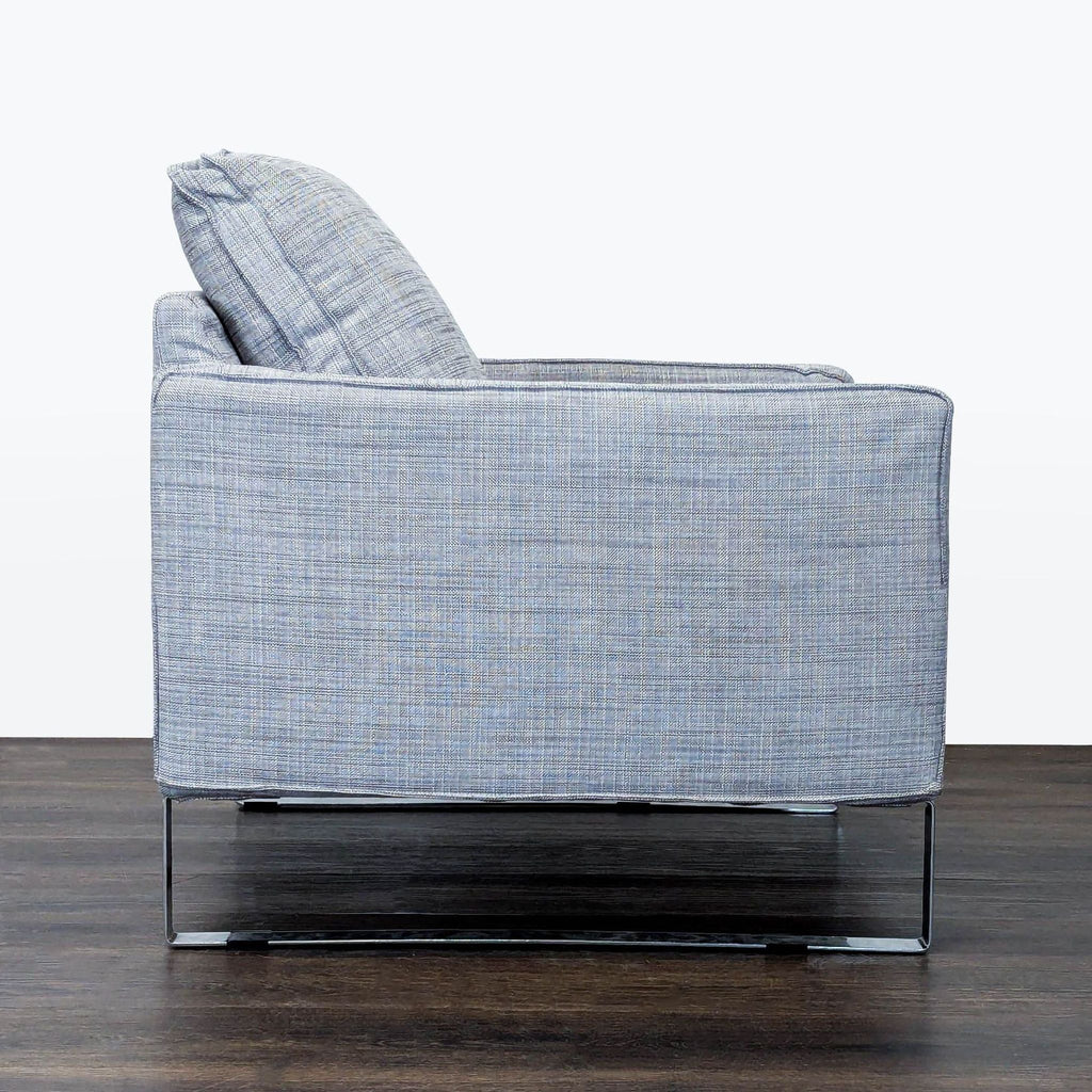 Ikea lounge chair with a sleek design, gray cushioned fabric, and sturdy metal base for comfortable seating.