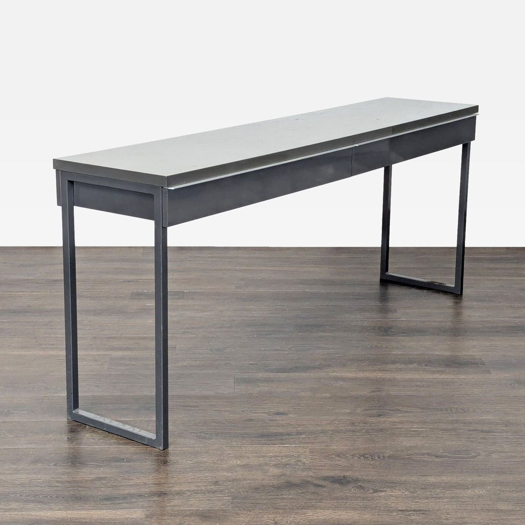 Sleek Ikea office desk in good condition, gray surface, metal legs, and double drawers for storage.