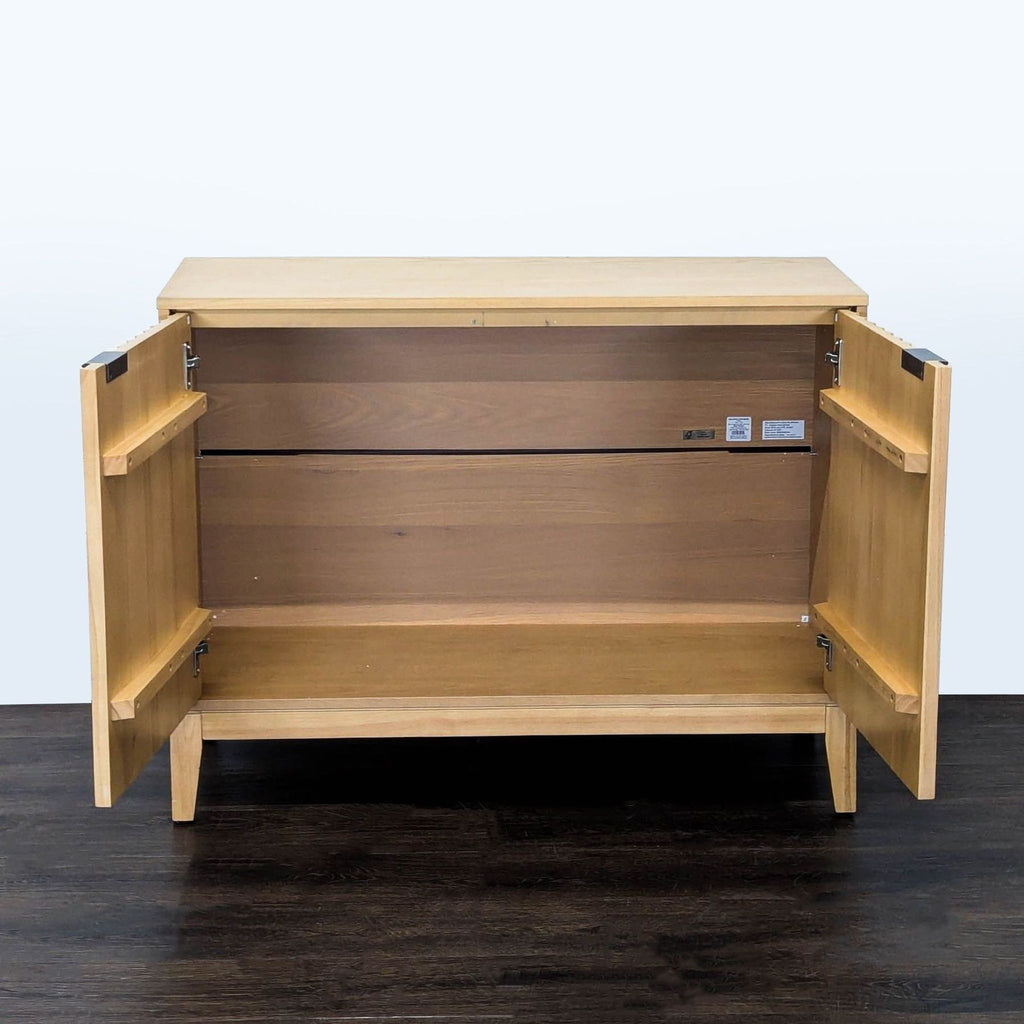 Contemporary wood cabinet by Nathan James featuring minimalist doors and sleek metal handles.