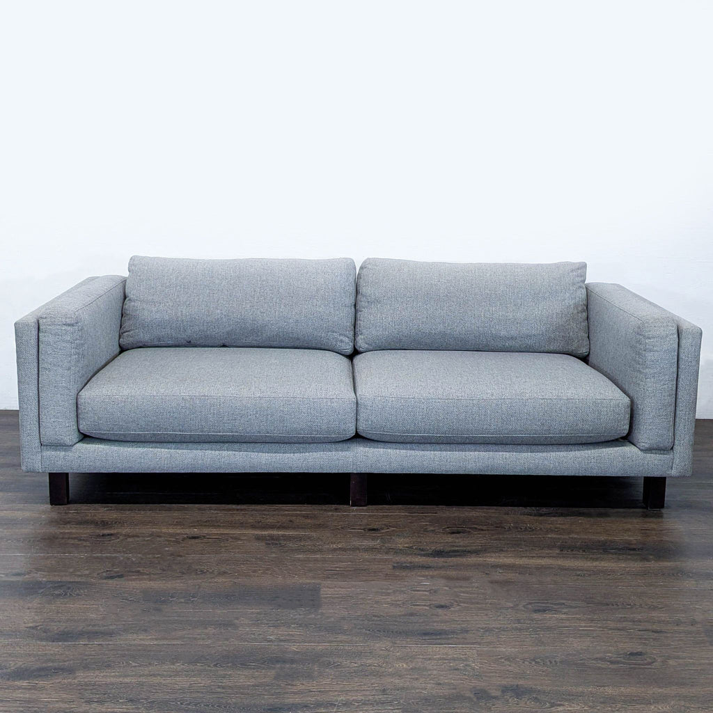 Room and Board 3-seat sofa with plush gray fabric, clean lines, and sturdy dark wood legs.