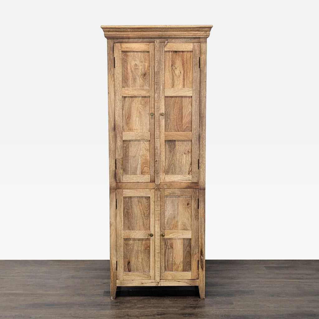 Natural wood cabinet with four paneled doors and internal shelves, photographed front-facing.