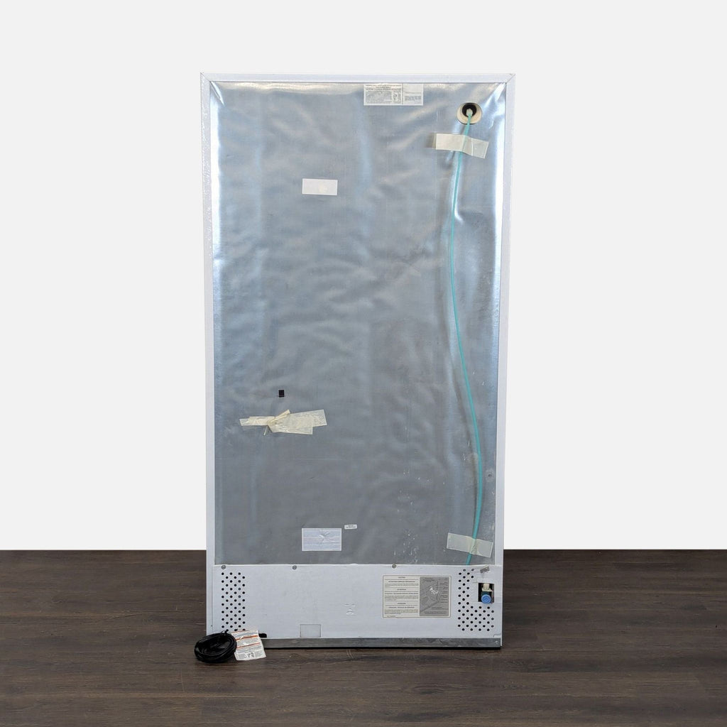 Spacious Frigidaire refrigerator in white, equipped with a built-in dispenser and ready for kitchen use.