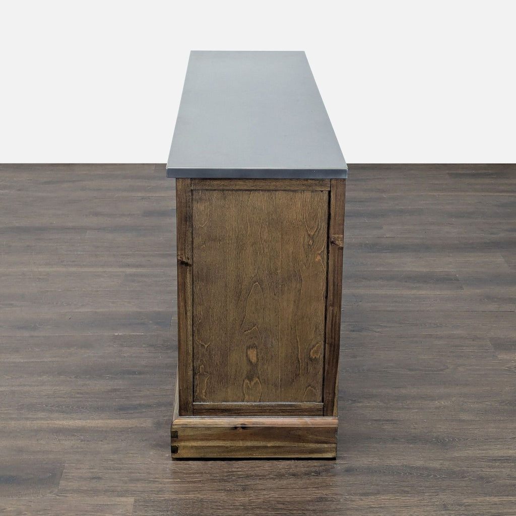 Entertainment center with four drawers, a storage shelf, and a metallic top; World Market.