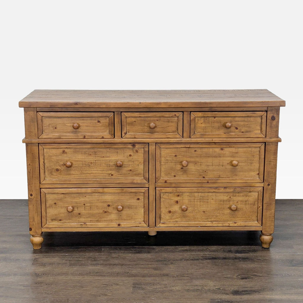 1. Front view of a Pottery Barn rustic pine dresser with eight drawers and classic wooden knobs.