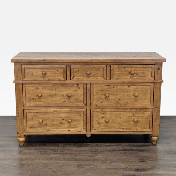1. Front view of a Pottery Barn rustic pine dresser with eight drawers and classic wooden knobs.