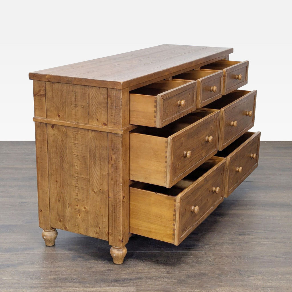 2. Angle view of Pottery Barn wooden dresser showing eight open spacious drawers and sturdy frame.