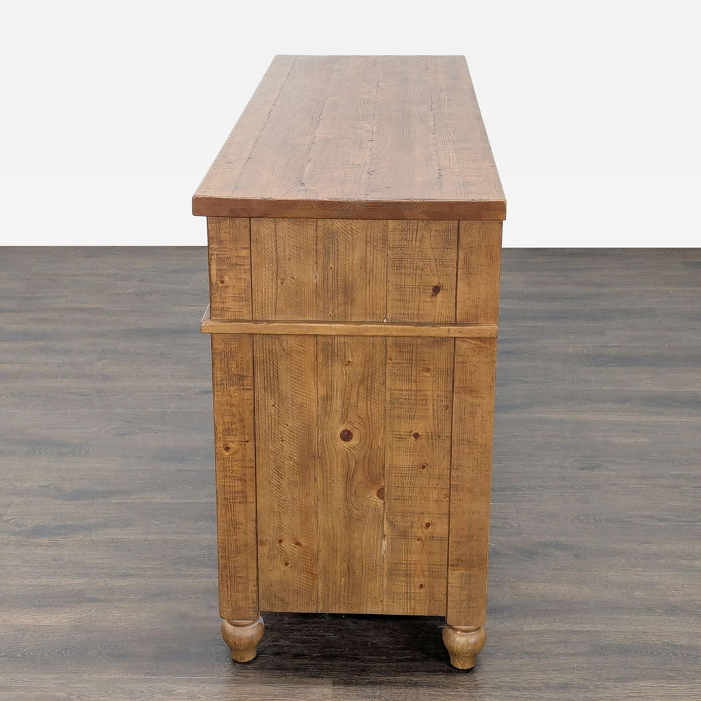 3. Side profile of a rustic Pottery Barn pine dresser, highlighting its textured wood grain and sturdy build.