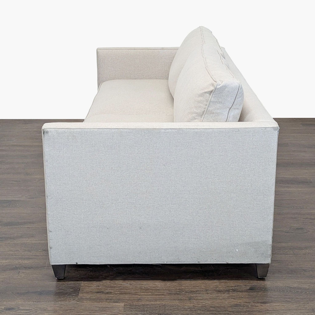 Stylish Crate & Barrel sofa seats three adults, with plush cushions, neutral fabric, and a sleek contemporary design.