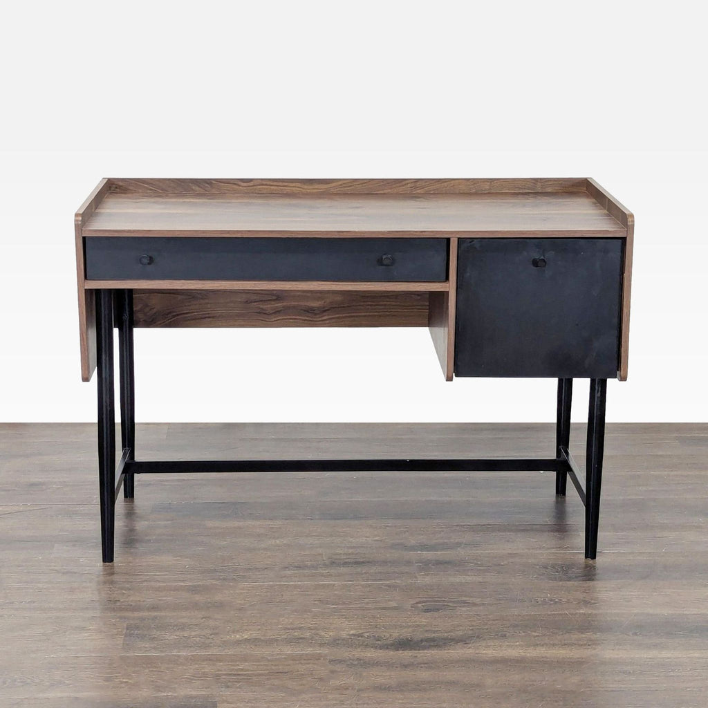 Sauder desk with a two-tone wood and black finish, spacious top, and sturdy black metal legs shown from the front.  