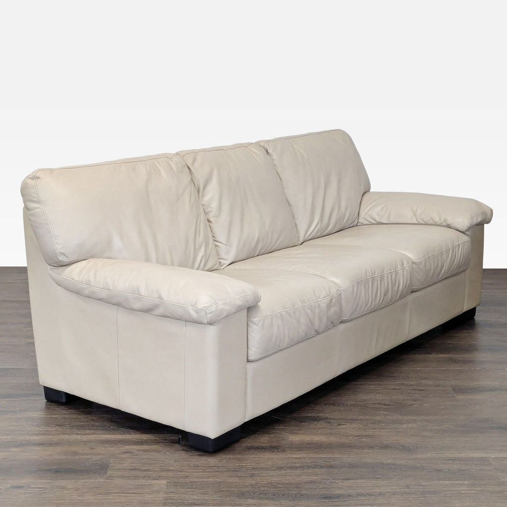Modern beige leather Italsofa sofa with sturdy frame, comfortable seating, and three seats for entertaining guests.