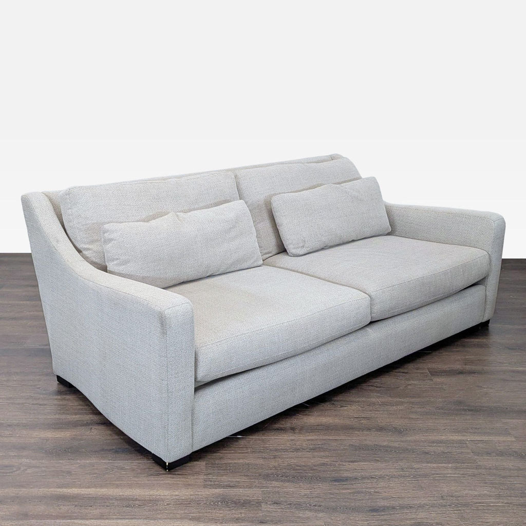 Light herringbone sofa by Crate and Barrel, comfortably seats three adults with a sleek, contemporary look.