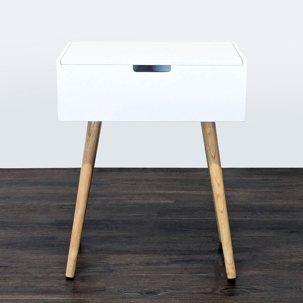 2. Modern white table with wood legs, closed boxy top and a minimalistic design, categorized as Other.