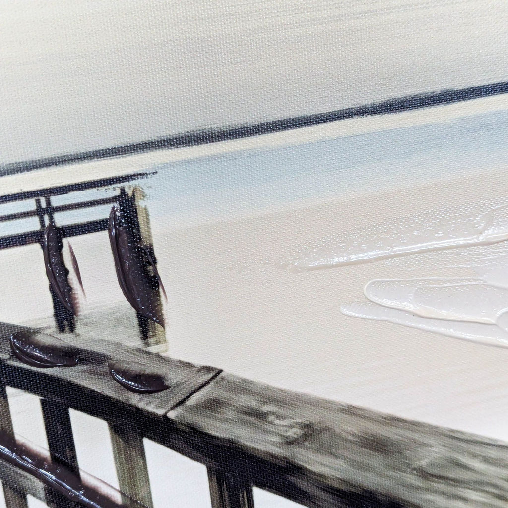 Framed artwork showing a wooden dock extending into tranquil water beneath a clear, bright sky.  