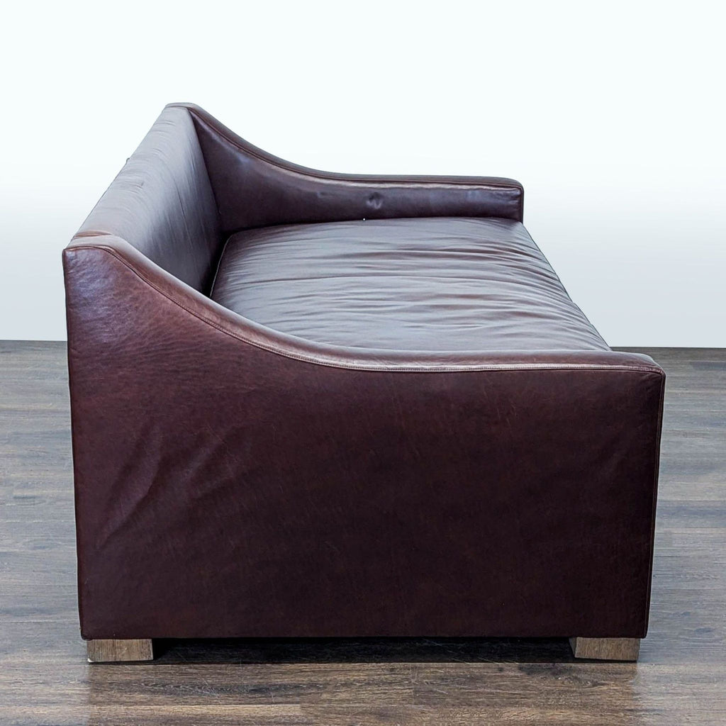 Modern brown leather 3-seater from Sugarhill Custom Upholstery, boasting sturdy wooden legs and a comfortable, spacious seat.