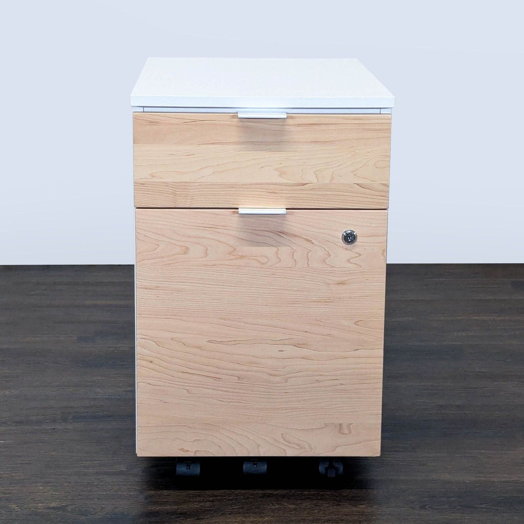 Modern office cabinet with wood front, white sides, two drawers, lock, and wheels for easy movement.