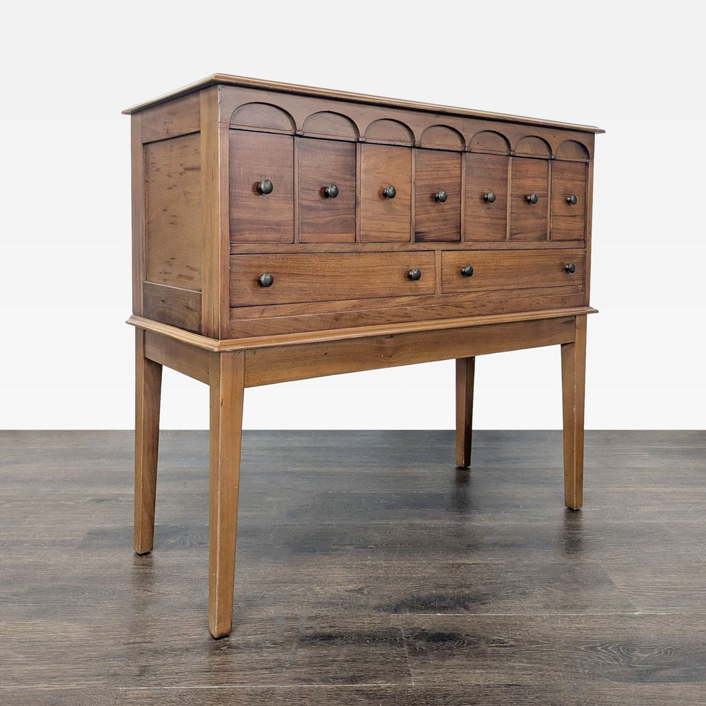 Three-quarter perspective of a nine-drawer credenza, emphasizing its warm wood finish and ample drawer storage.