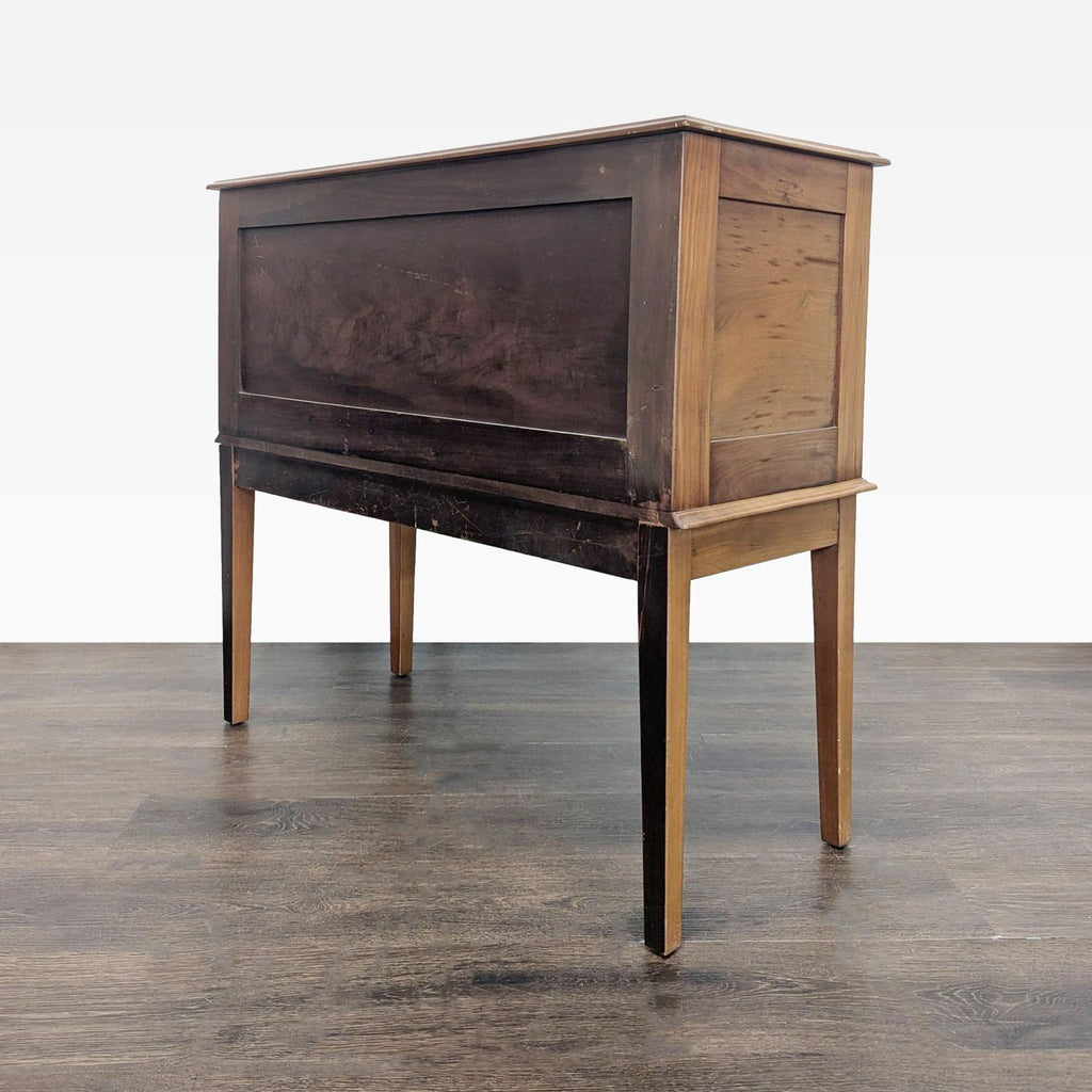 Side angle of a mid-century wooden sideboard server, showcasing panel details and tapered legs.  