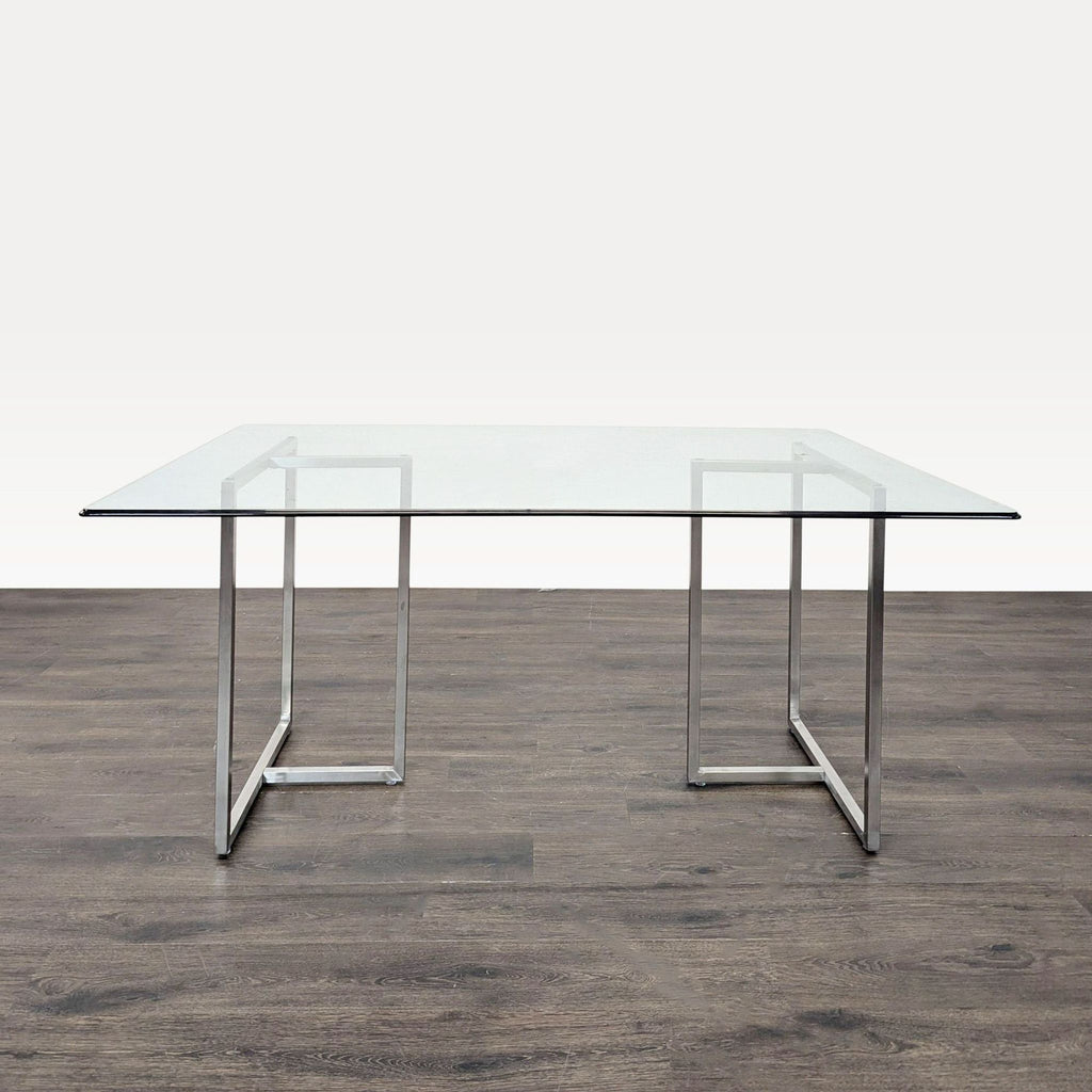 Contemporary rectangular glass table paired with matching transparent chairs for a sleek dining area.