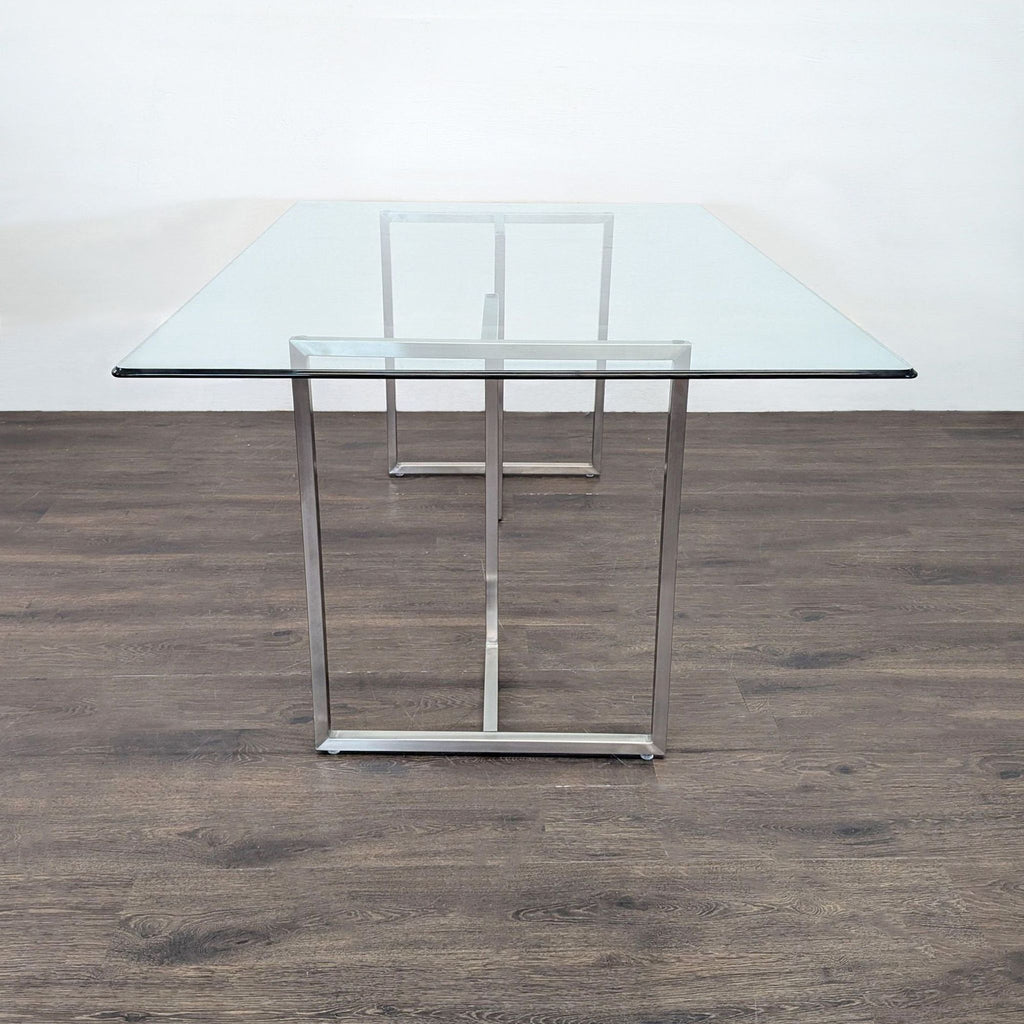 3. Side view of a large glass dining table with a minimalist metal frame, ideal for a modern dining space.