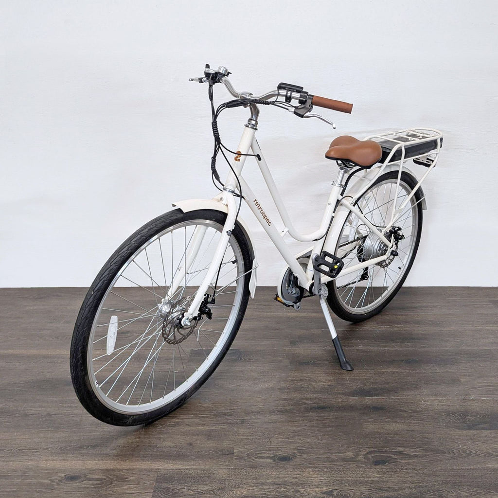Modern Retrospec city e-bike, featuring a rear rack, stylish brown accents, and a comfortable, easy-mount frame.