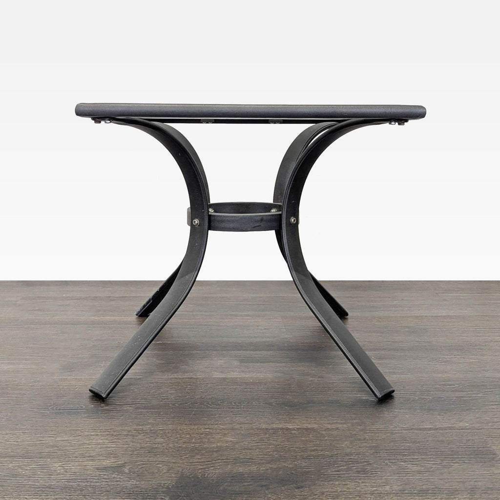 2. Modern square table featuring sturdy black metal construction and stylish curved supports for added stability.  