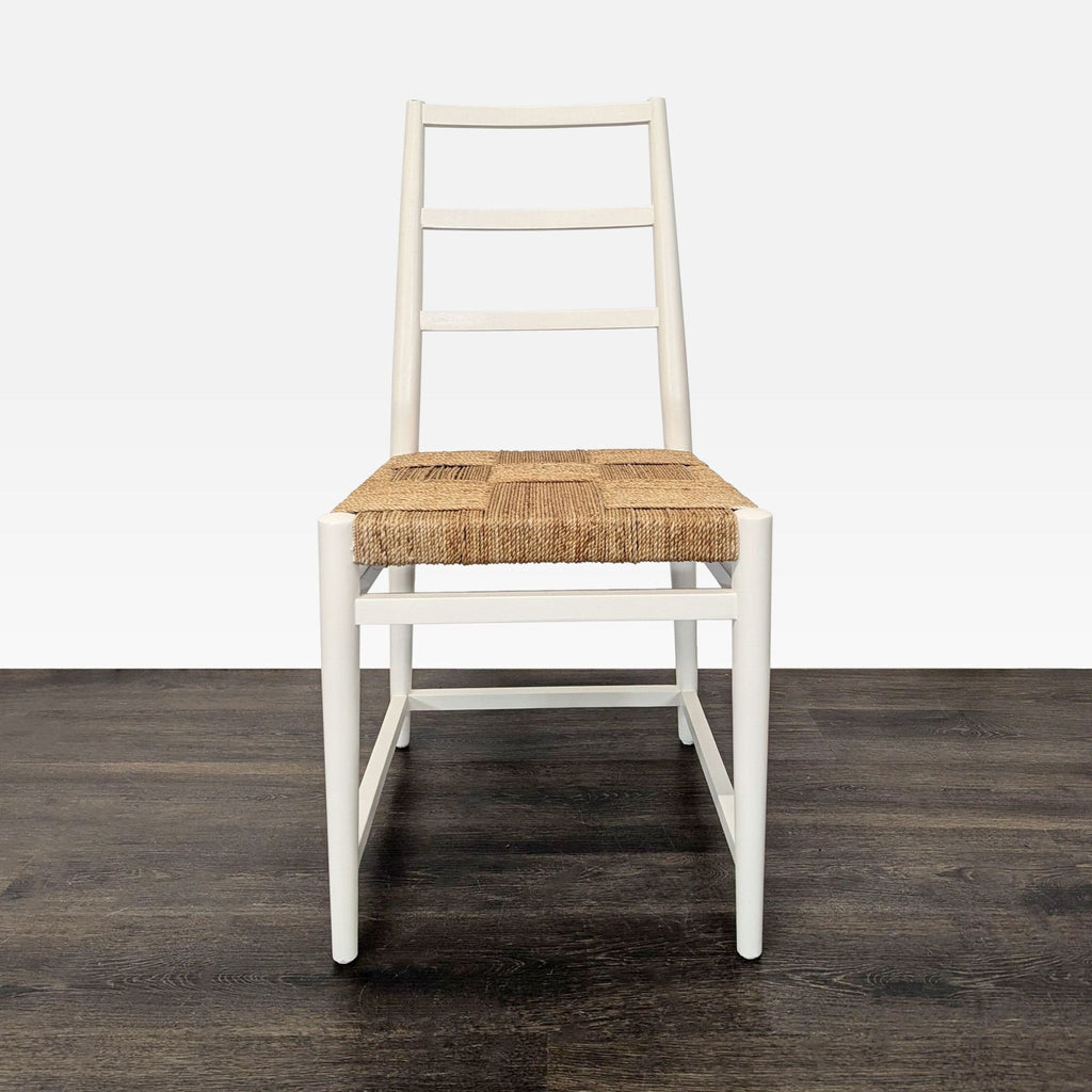 Front view of a white dining chair featuring a ladder back and square woven natural fiber seat.