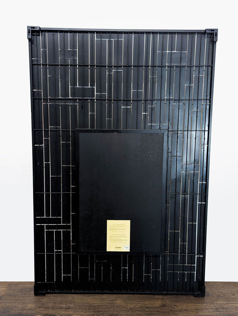Back view of a Pier 1 Imports mirror showing the black metal frame and mounting hardware.  