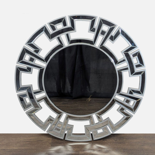 Mirror with a geometric wooden frame and glass accents around the central reflective surface.  