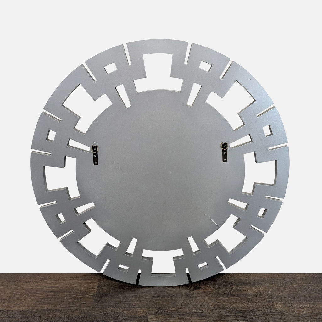 Wall mirror featuring a wood border in a geometric pattern with glass inserts surrounding the main mirror.  