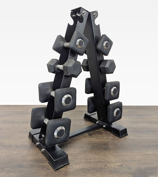 A compact Peloton dumbbell set with weights from 10 to 25 lbs neatly organized on a sturdy rack.