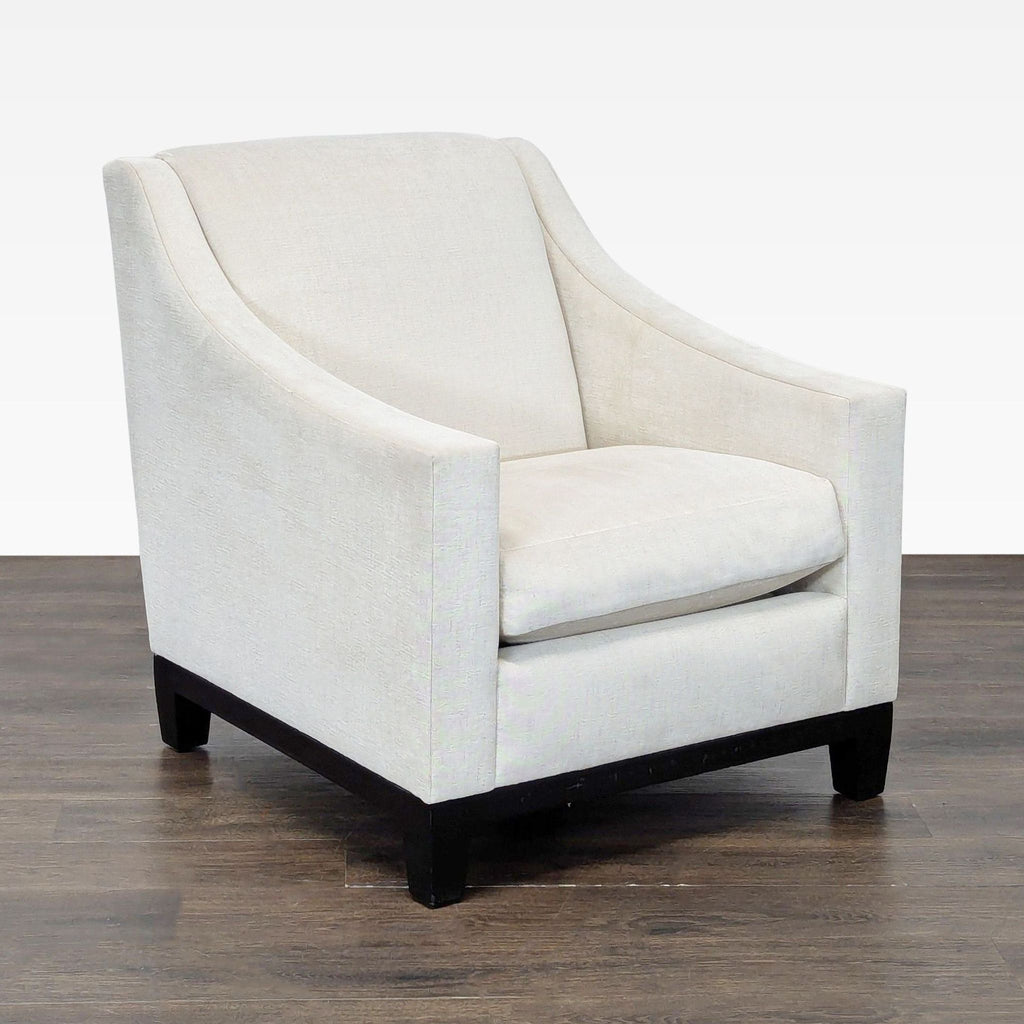 Elegant ivory A. Rudin armchair with dark wood base, plush feather-down cushion, and contemporary lines.