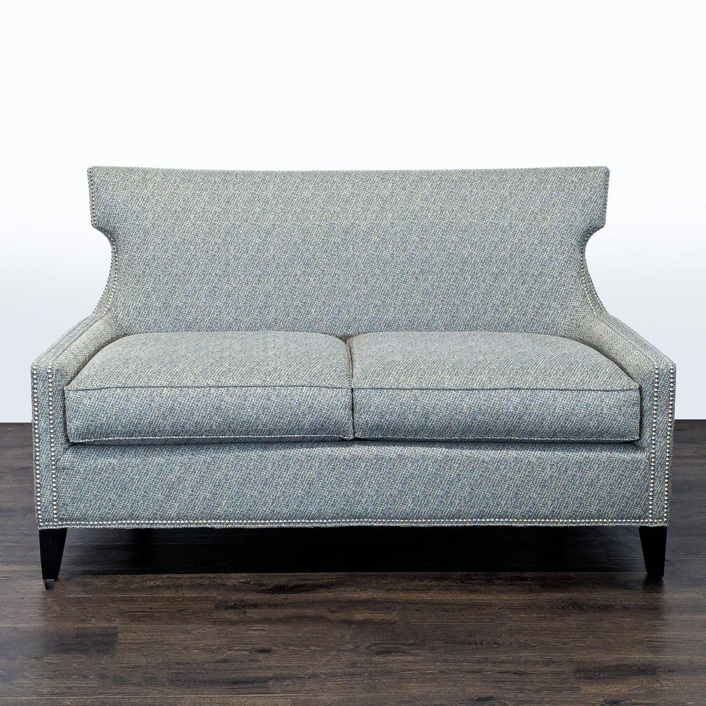 Thomasville loveseat with soft grey fabric, nailhead trim, and dark wood legs, seats two comfortably.