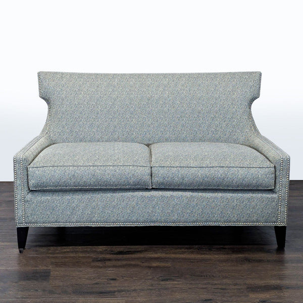 Thomasville loveseat with soft grey fabric, nailhead trim, and dark wood legs, seats two comfortably.