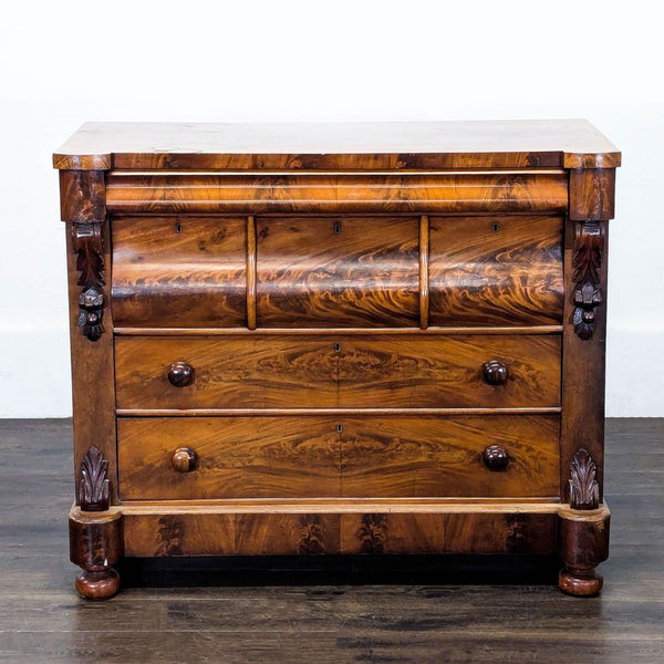 Antique American Empire mahogany chest with ogee drawers, carved corbels, and turned feet, mid-19th century.  