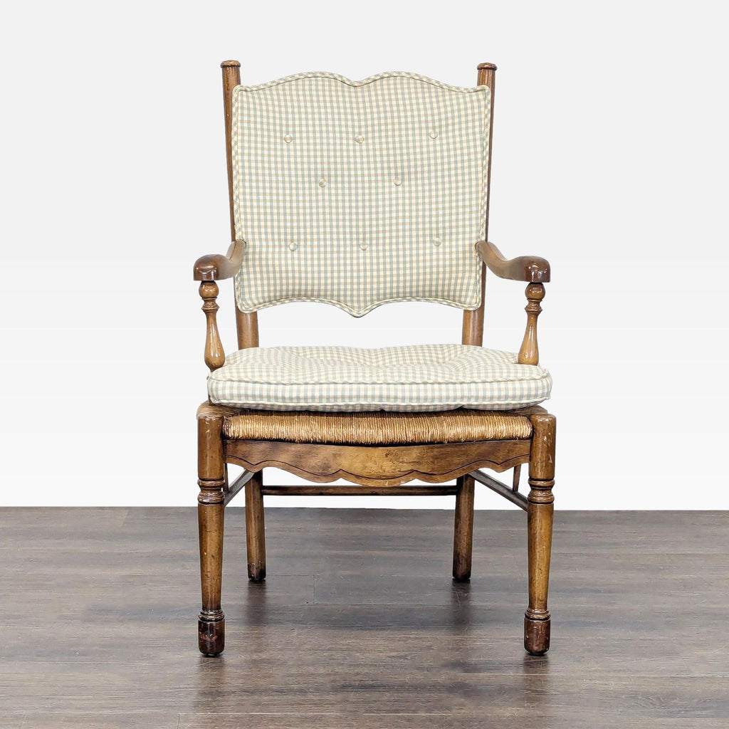 Front view of a Country French dining chair with button-tufted gingham cushions and carved wood arms.