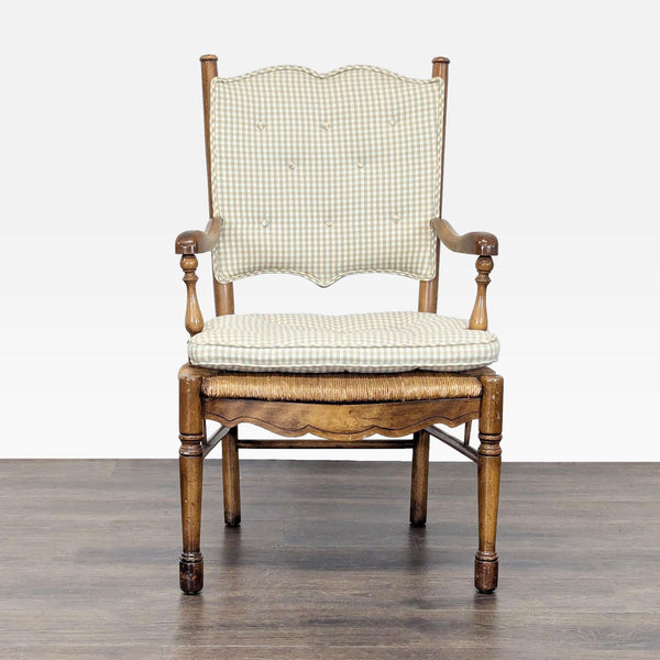 Front view of a Country French dining chair with button-tufted gingham cushions and carved wood arms.