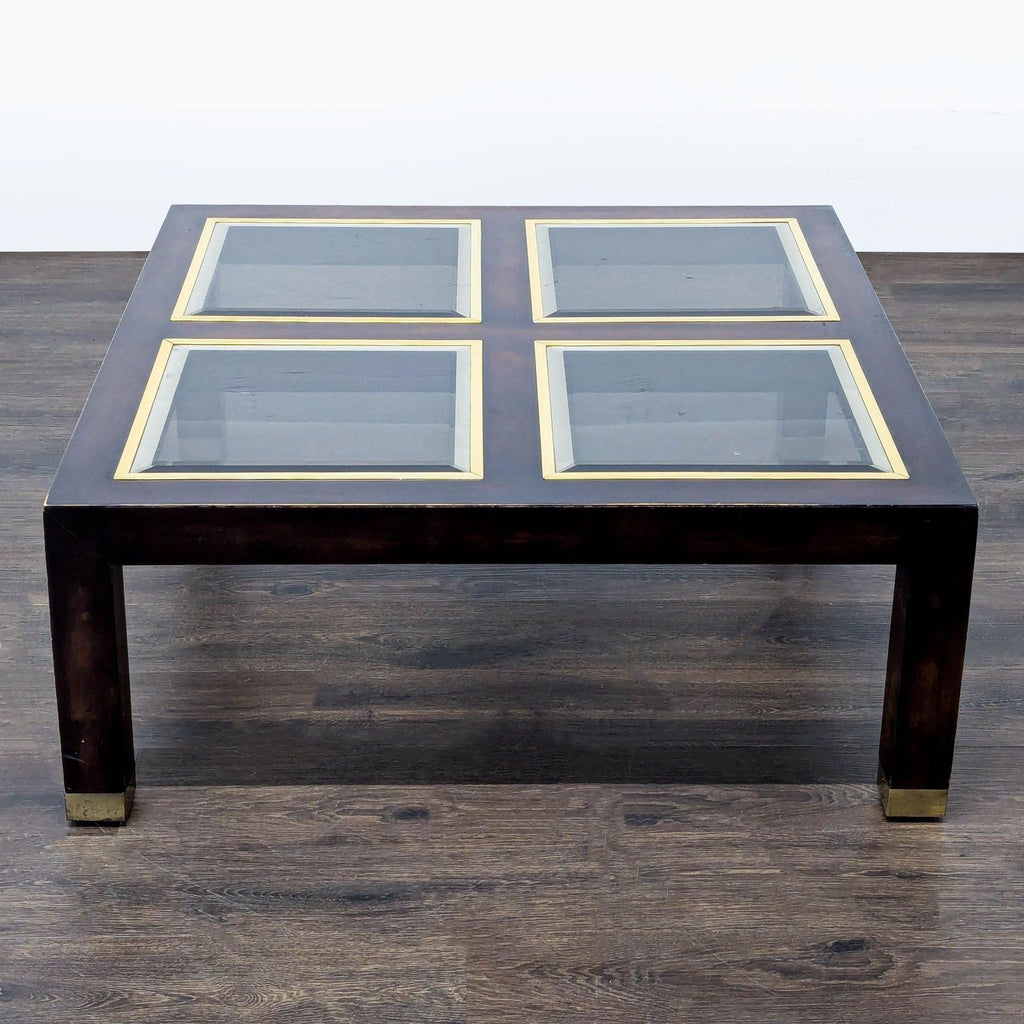3. Coffee table with dark wood, four glass squares framed in gold, and metal foot caps.