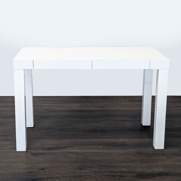 Modern West Elm white desk with minimalist design, two drawers, and sturdy build for versatile home use.  