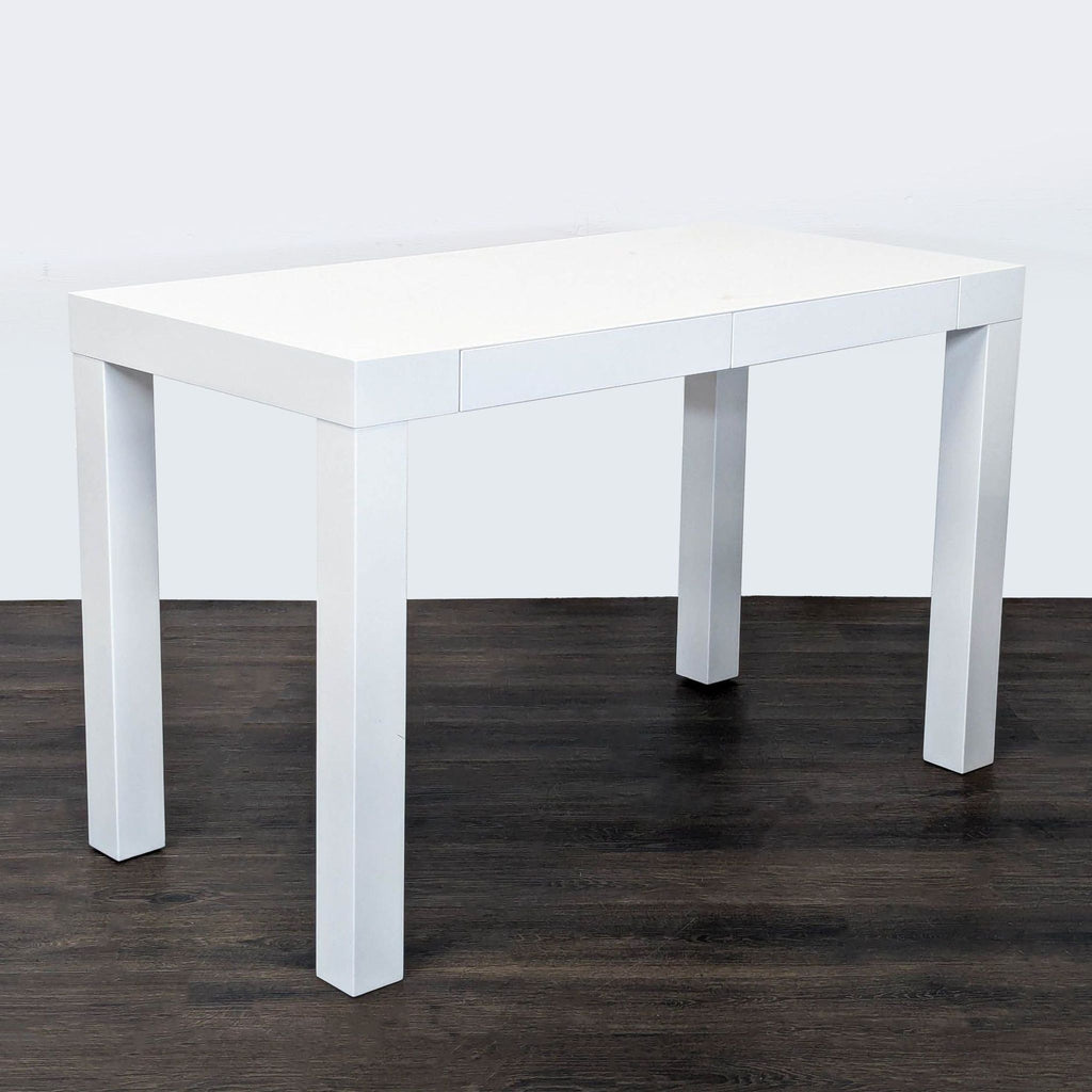 Minimalist West Elm desk in white with two drawers for storage, ideal for home offices or bedrooms.