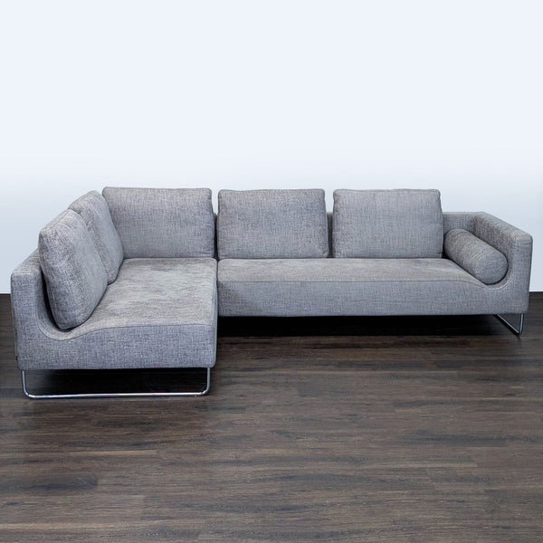 Modern Benson Canyan gray sectional with metal legs, L-shaped design, and plush cushions for spacious comfort.  