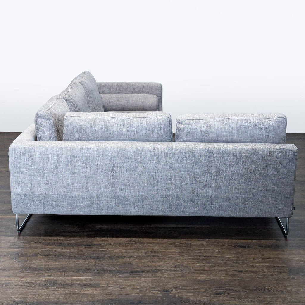 Benson Canyan sectional sofa in gray fabric with clean lines, comfortable cushions, and sturdy modern metal legs.