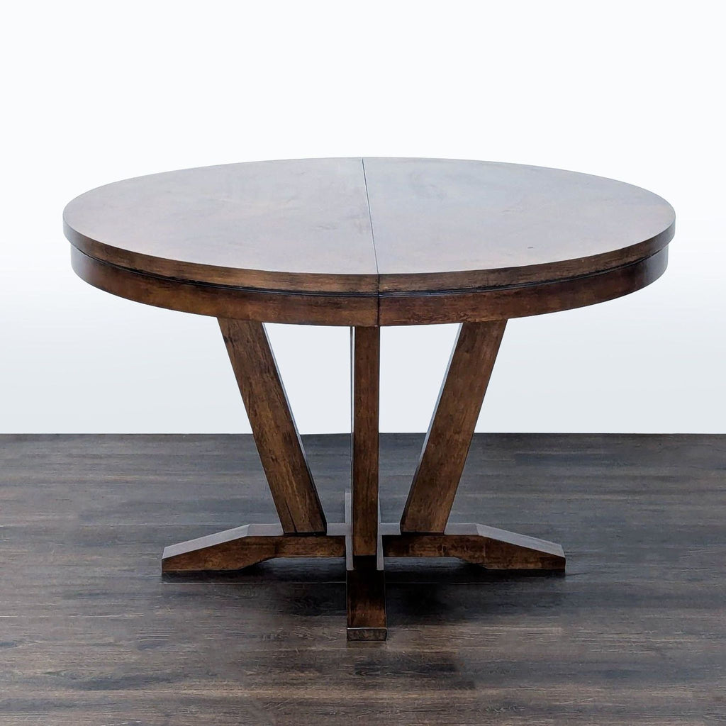 Expandable dining table by Legacy Classic, seats 4–6, featuring a saddle brown veneered top.  