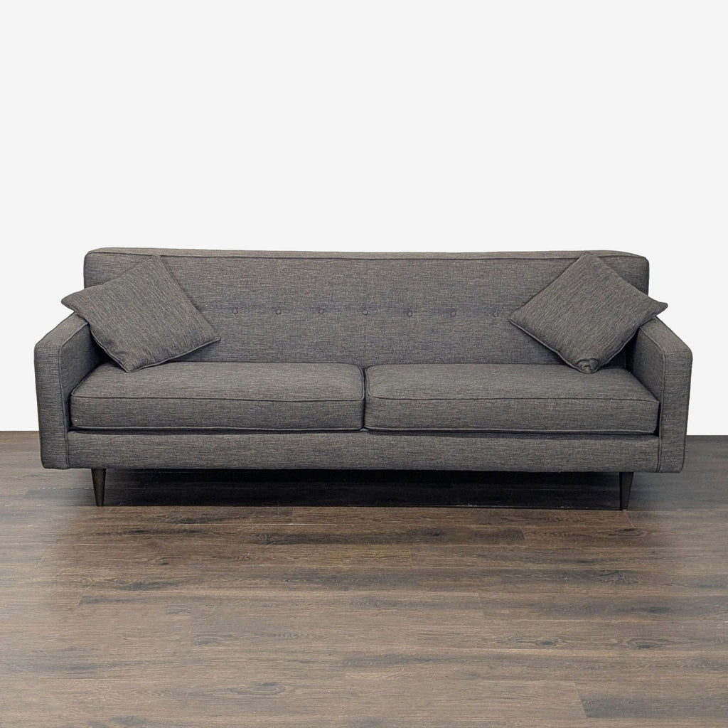 Modern dark grey 3-seat sofa with clean lines, button back, and two matching cushions for comfort.