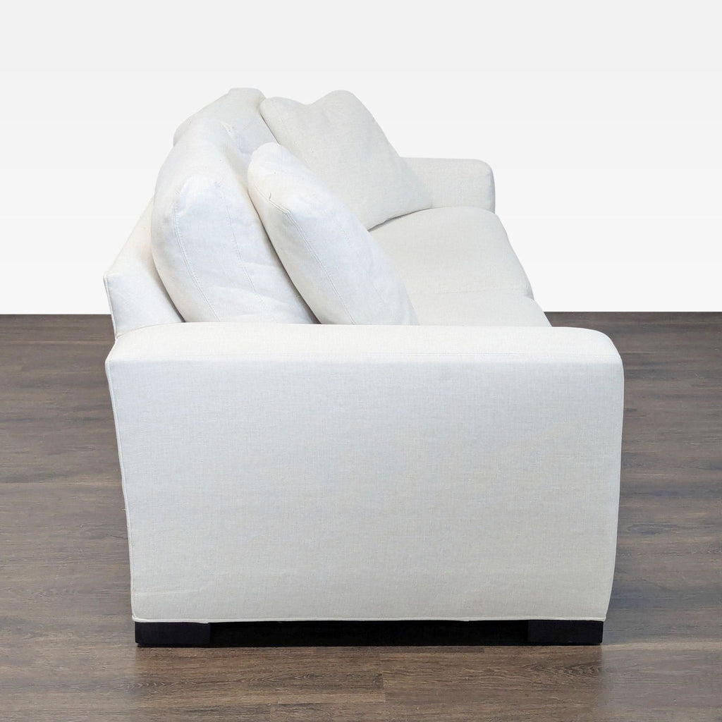 3. Side profile of a Room & Board 3-seat light-colored sofa with thick seat and back cushions.