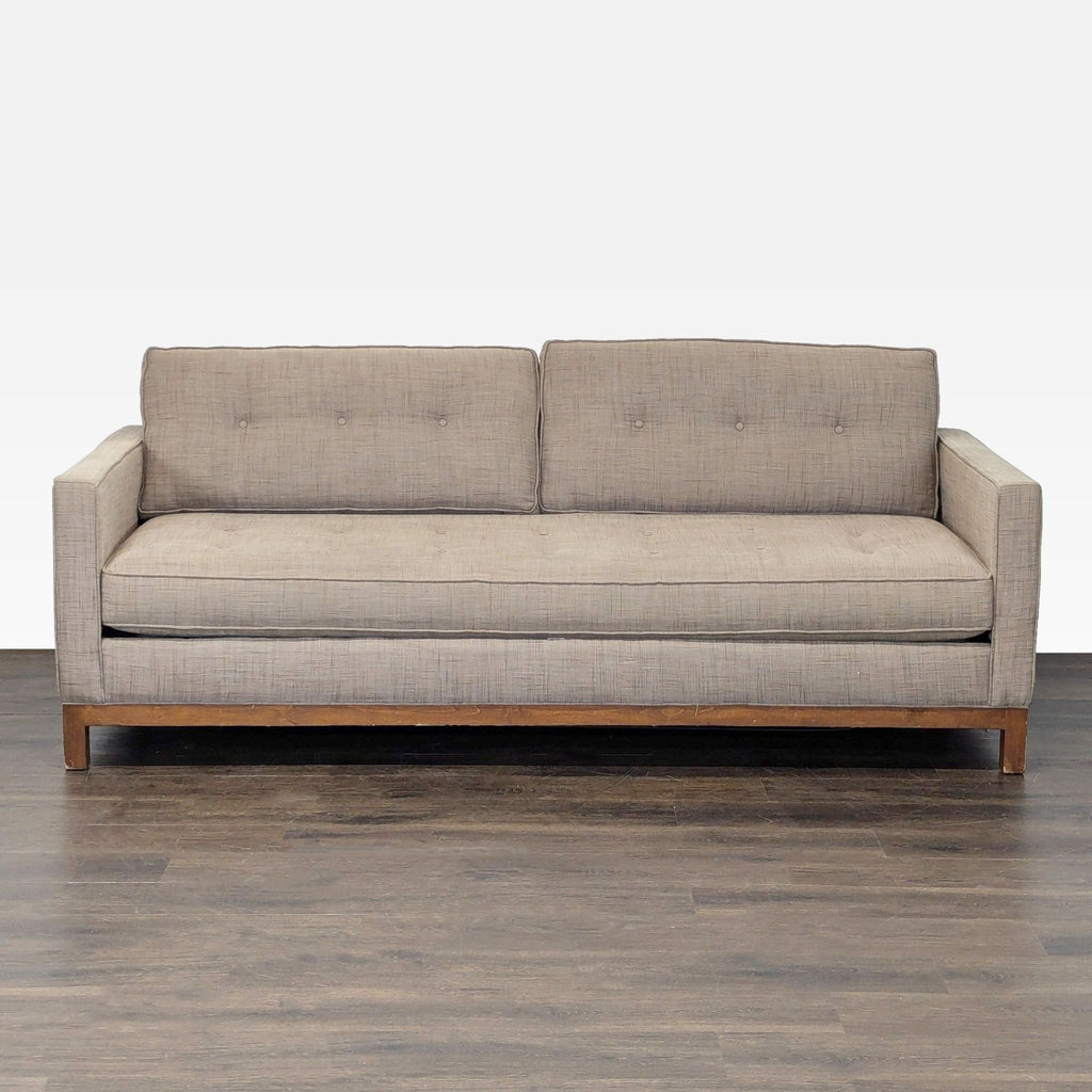 Tan modern sleeper sofa with straight arms, button-tufted back, and wooden base, perfect for living rooms.  