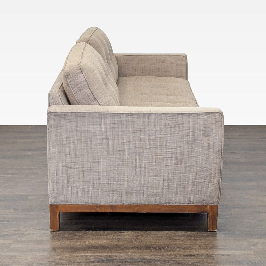 Stylish tan sleeper sofa features a tufted back, straight arms, and easily transitions from seating to bed.