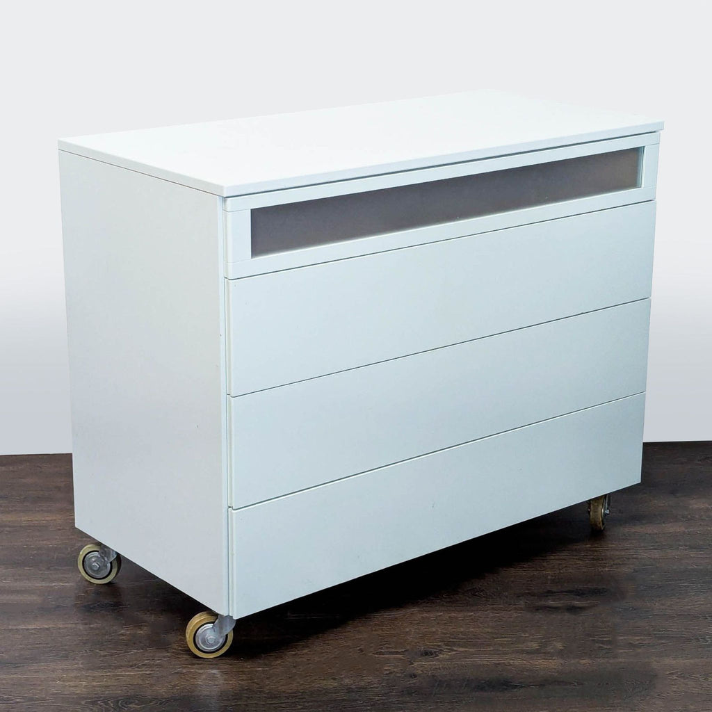 Contemporary dresser with clean lines, a frosted top drawer, and wheels for flexible placement.