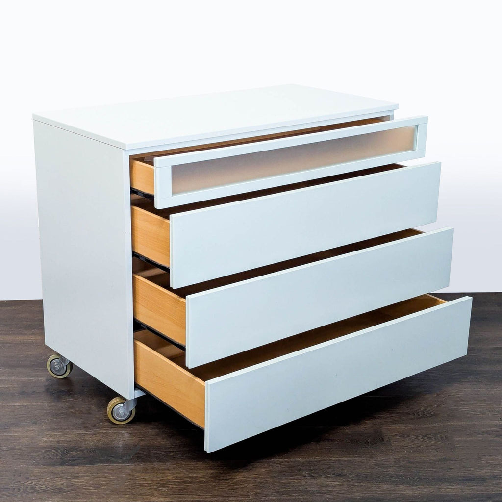 Sleek white dresser featuring spacious storage drawers and built-in casters for convenient movement.